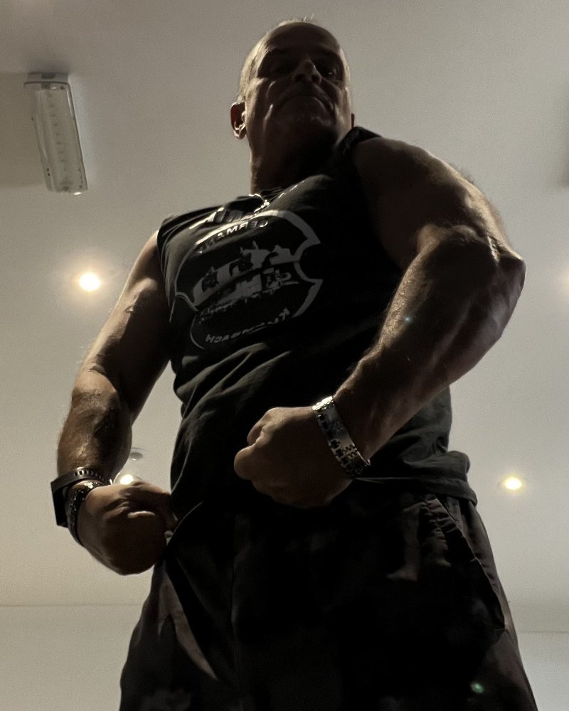 Gay Personal Trainer - Coach G flexing his muscles photo